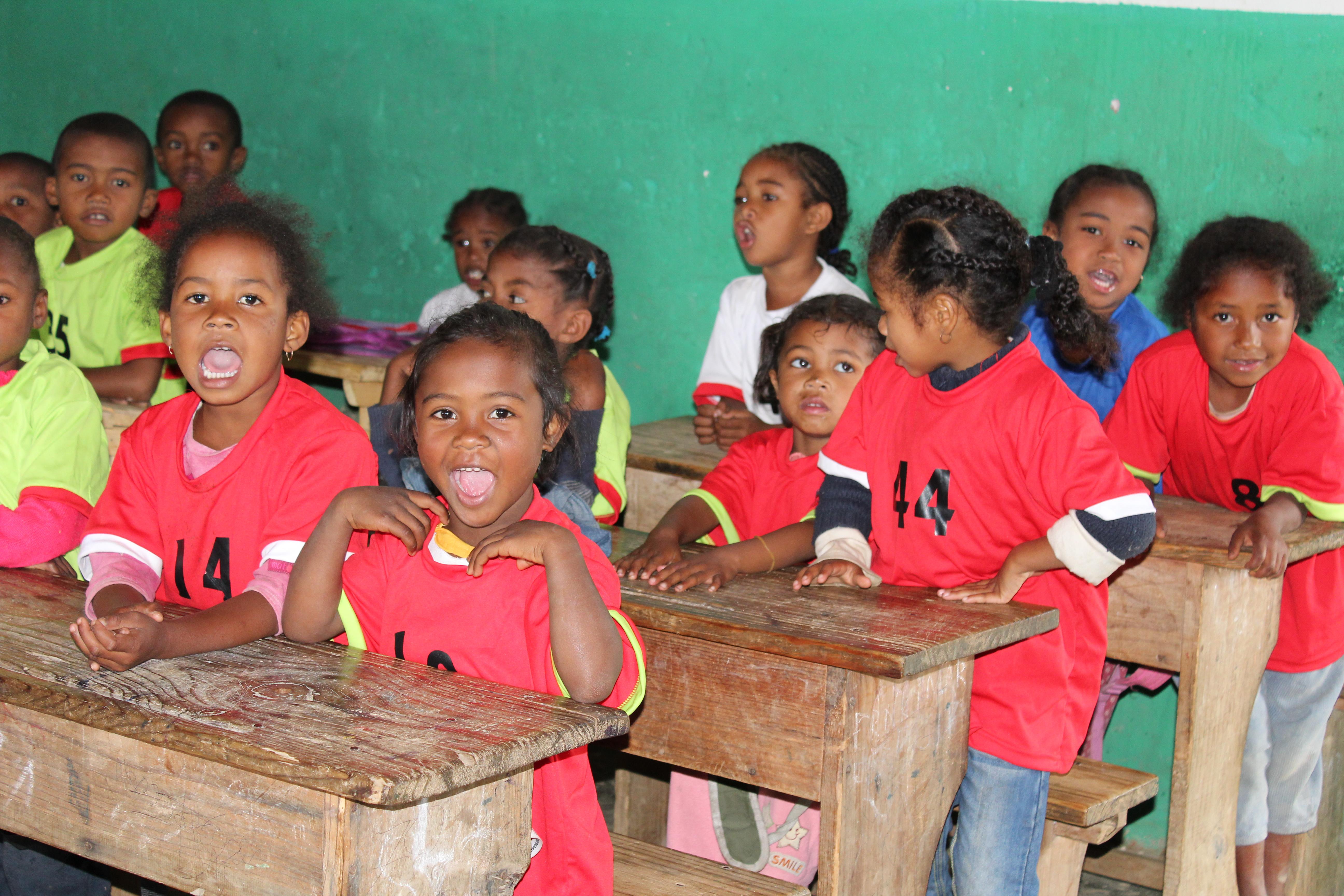 Children sit in their desks while a volunteer is teaching in Madagascar Students sitting in their desks at our volunteer teaching placements in Madagascar